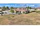 Aerial view of a home with covered RV parking and a large grassy area at 561 Meandering Way, Polk City, FL 33868