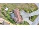 Top-down view of a home with a tiled roof, driveway, and landscaped yard at 561 Meandering Way, Polk City, FL 33868