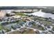 A sweeping aerial view captures the home nestled near a lake at 561 Meandering Way, Polk City, FL 33868
