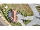 Top down aerial view of the home, showcasing its tile roof, driveway, and landscaping at 561 Meandering Way, Polk City, FL 33868
