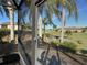 View from screened lanai to backyard, pond, and neighboring homes at 561 Meandering Way, Polk City, FL 33868