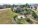 Tropical backyard with screened lanai, fire pit, lush landscaping, and RV garage at 561 Meandering Way, Polk City, FL 33868