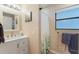 Bathroom with white vanity, shower, and window at 561 Meandering Way, Polk City, FL 33868