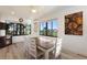 Dining area with table, chairs, and view of the backyard at 561 Meandering Way, Polk City, FL 33868