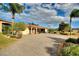 Single-story home with landscaped yard, paver driveway, and attached garage at 561 Meandering Way, Polk City, FL 33868