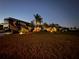 Large RV parked on the spacious lawn of a single-Gathering home at night at 561 Meandering Way, Polk City, FL 33868
