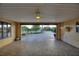 Paved driveway and garage with open door, showing the interior and landscaping at 561 Meandering Way, Polk City, FL 33868
