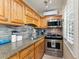 Fully equipped kitchen with modern appliances and granite countertops at 561 Meandering Way, Polk City, FL 33868