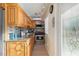 Compact kitchen featuring light wood cabinets, stainless appliances, and granite counters at 561 Meandering Way, Polk City, FL 33868
