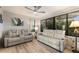 Inviting living area featuring dual reclining sofas, ceiling fan, and ample natural light at 561 Meandering Way, Polk City, FL 33868