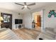 Open-concept living room flowing into the kitchen, with reclining sofas and entertainment center at 561 Meandering Way, Polk City, FL 33868