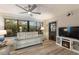 Cozy living room with leather reclining sofa, TV, and electric fireplace at 561 Meandering Way, Polk City, FL 33868