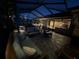 Covered patio with outdoor kitchen, seating area, and access to the garage at 561 Meandering Way, Polk City, FL 33868