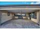 Covered patio with brick pavers and outdoor furniture at 561 Meandering Way, Polk City, FL 33868