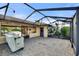 Large, screened-in patio with a covered grilling station at 561 Meandering Way, Polk City, FL 33868