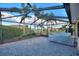 Screened patio with grill, pavers, and view of the community at 561 Meandering Way, Polk City, FL 33868