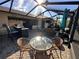 Outdoor screened patio with seating area, grill, and dining table at 561 Meandering Way, Polk City, FL 33868