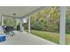 Covered patio with outdoor furniture, grill, and view of private backyard at 585 Scott Lake Creek Ln, Lakeland, FL 33813