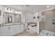 Modern bathroom with double vanity, soaking tub, glass shower, and tiled floor at 585 Scott Lake Creek Ln, Lakeland, FL 33813