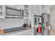 Stainless steel appliances, including a microwave, oven, and refrigerator, in the modern kitchen at 585 Scott Lake Creek Ln, Lakeland, FL 33813