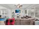 Living room featuring a large sectional sofa, a fireplace, and a TV mounted on the wall at 585 Scott Lake Creek Ln, Lakeland, FL 33813