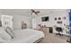 Large main bedroom with wall-mounted TV, soft carpet, and ceiling fan at 585 Scott Lake Creek Ln, Lakeland, FL 33813