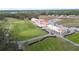 Aerial view of clubhouse and golf course at 6029 Avocado Dr, Indian Lake Estates, FL 33855