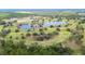 Aerial view of the golf course and lake at 6029 Avocado Dr, Indian Lake Estates, FL 33855
