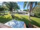Spacious backyard with patio, shed, and lush lawn at 6029 Avocado Dr, Indian Lake Estates, FL 33855