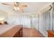 Bright bedroom with wood floors and access to hallway at 6029 Avocado Dr, Indian Lake Estates, FL 33855