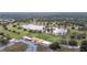 Aerial view of the community clubhouse near the golf course and pond at 6029 Avocado Dr, Indian Lake Estates, FL 33855