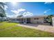 Spacious patio and screened enclosure adjacent to the house at 6029 Avocado Dr, Indian Lake Estates, FL 33855