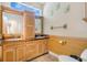 Modern bathroom with double vanity, wooden cabinetry, and tile flooring at 6818 Hayter Drive, Lakeland, FL 33813