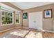 Bedroom with large windows, hardwood floors, and framed sports jerseys at 6818 Hayter Drive, Lakeland, FL 33813