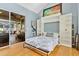 Bedroom with Murphy bed, built-in shelving, and access to the patio at 6818 Hayter Drive, Lakeland, FL 33813