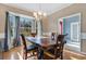 Dining room with hardwood floors, large windows, and a view of the entryway at 6818 Hayter Drive, Lakeland, FL 33813