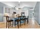 Updated kitchen featuring white cabinetry, granite countertops, and a breakfast bar at 6818 Hayter Drive, Lakeland, FL 33813