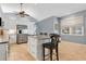 Bright kitchen with white cabinets, stainless steel appliances, and an island with seating at 6818 Hayter Drive, Lakeland, FL 33813