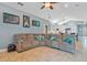 Spacious living room with a large sectional sofa and access to the adjacent kitchen and dining area at 6818 Hayter Drive, Lakeland, FL 33813