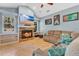 Welcoming living room with a fireplace, large windows, and built-in shelving at 6818 Hayter Drive, Lakeland, FL 33813