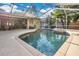 Large screened pool and hot tub with surrounding patio and seating at 6818 Hayter Drive, Lakeland, FL 33813