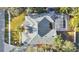 An aerial close-up of the home's roof, screened pool enclosure, and backyard at 6818 Hayter Drive, Lakeland, FL 33813