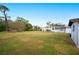 Large backyard with grassy area and detached shed at 1568 S Lake Shipp Dr, Winter Haven, FL 33880