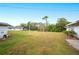 Spacious backyard with grassy area and trees at 1568 S Lake Shipp Dr, Winter Haven, FL 33880