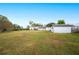 Spacious backyard featuring a detached shed and grassy lawn at 1568 S Lake Shipp Dr, Winter Haven, FL 33880