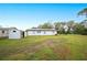 Large backyard with a shed and a long white house at 1568 S Lake Shipp Dr, Winter Haven, FL 33880