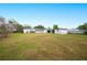 Backyard view showing a large grassy area and a shed at 1568 S Lake Shipp Dr, Winter Haven, FL 33880