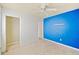 Simple bedroom with blue walls and ceiling fan at 1568 S Lake Shipp Dr, Winter Haven, FL 33880
