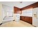 Kitchen with wood cabinets and access to living room at 1568 S Lake Shipp Dr, Winter Haven, FL 33880