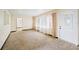 Living area with carpeted floor and large window at 1568 S Lake Shipp Dr, Winter Haven, FL 33880